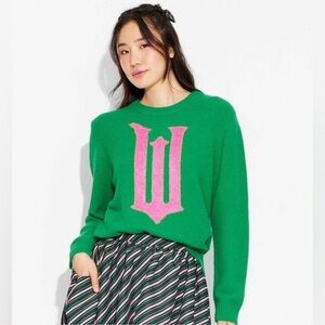 Women’s graphic sweater in green w pink graphic “W” from the movie Wicked XXS
